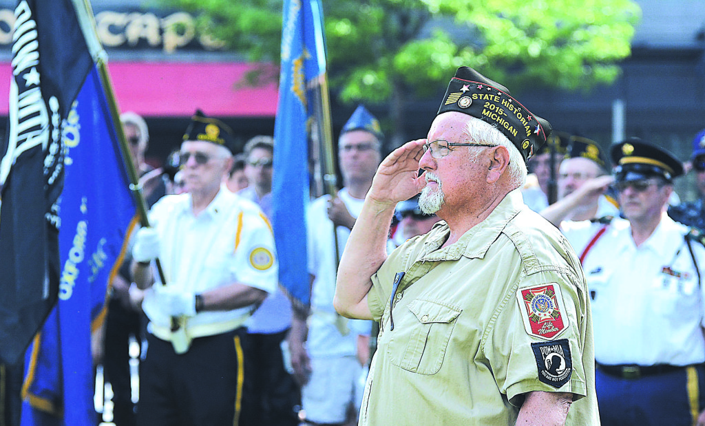 Oxford resident Jim Muys, a veteran of the U.S. Navy and Vietnam War, salutes during the Memorial Day observance in downtown Oxford’s Centennial Park. Photo by CJC.