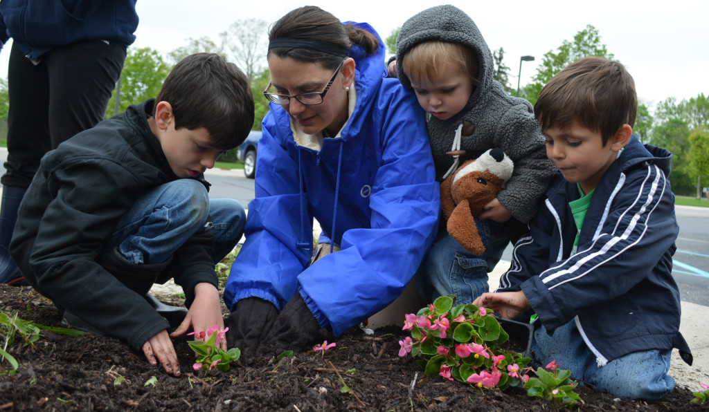 Planting flowers outside the Oxford Township Hall are (from left) Cub Scout Luca Bolognesi, Laura Bolognesi, Leo Bolognesi and Cub Scout GianMarco Bolognesi. Photo by C.J. Carnacchio.