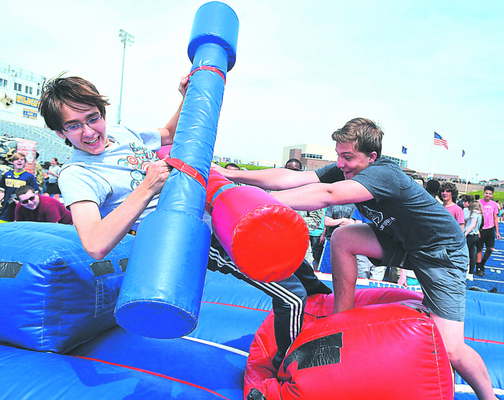 OHS student Seth Parris (left) gets knocked off his pedestal – literally. Photo by C.J. Carnacchio.