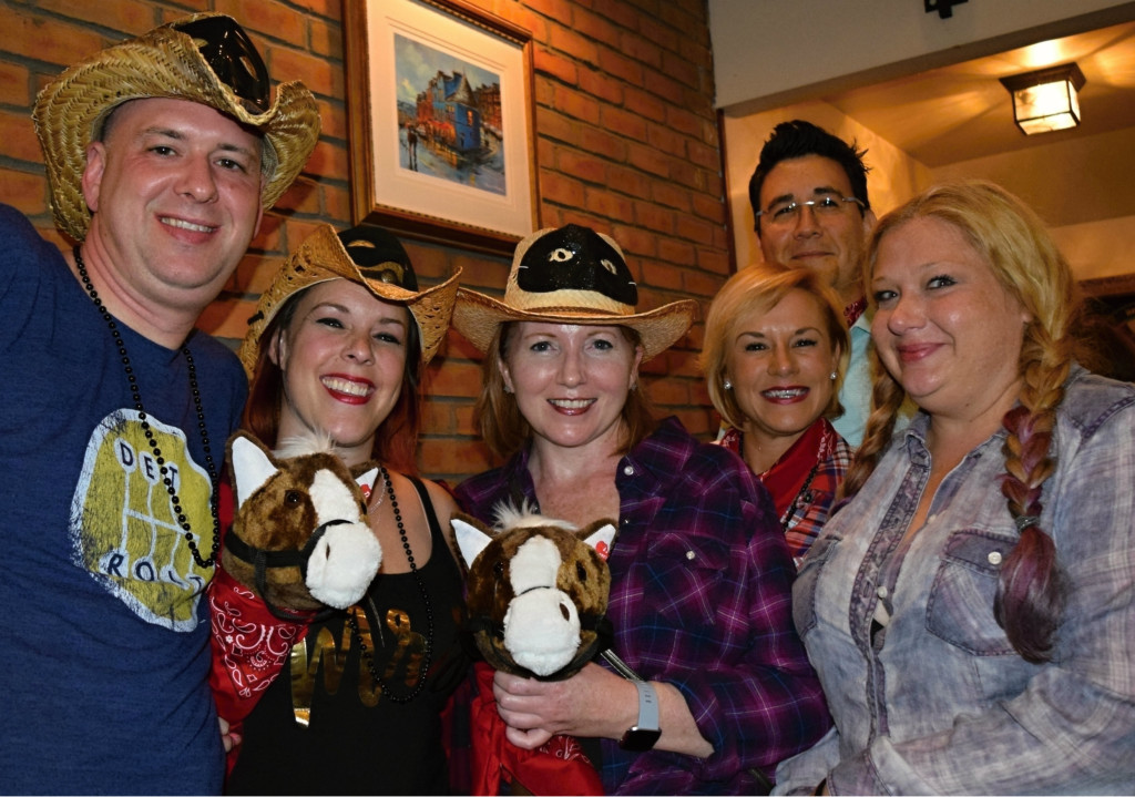 Boston residents Ryan Friel (from left) and Stephanie Friel, Oxford resident Anna Omara, and Orion residents Jennifer Fuller, Alejandro Plazas and Missy Hedgcock enjoy the Pub Crawl in Lone Ranger-fashion at Sullivan’s Public House in downtown Oxford.
