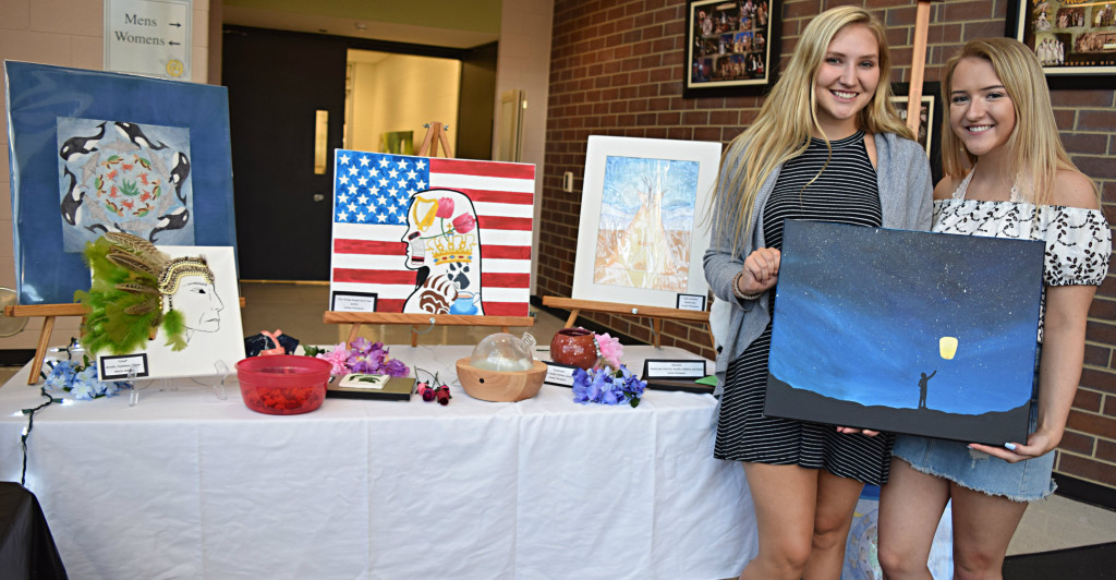 OHS seniors Carlee Thompson and Alexis Jahlas show off their art. Photo by Elise Shire.