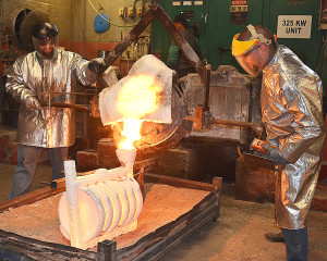 RLM Industries employees pour molten metal into ceramic molds for 13-inch cast-iron skillets that will be sold by the Royal Oak-based Marquette Castings. Photo by C.J. Carnacchio.