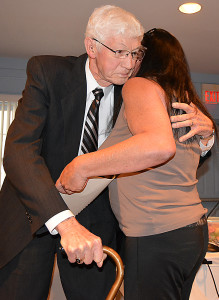 Joe Bullen hugs Councilwoman Maureen Helmuth, who created a resolution for him that praised his character, his leadership and his selfless commitment to Oxford Village. Photo by C.J. Carnacchio.