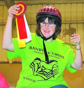 Banbury Cross rider Ashley Baarck beams with pride as she holds up the ribbon and trophy she earned. Photo by C.J. Carnacchio.