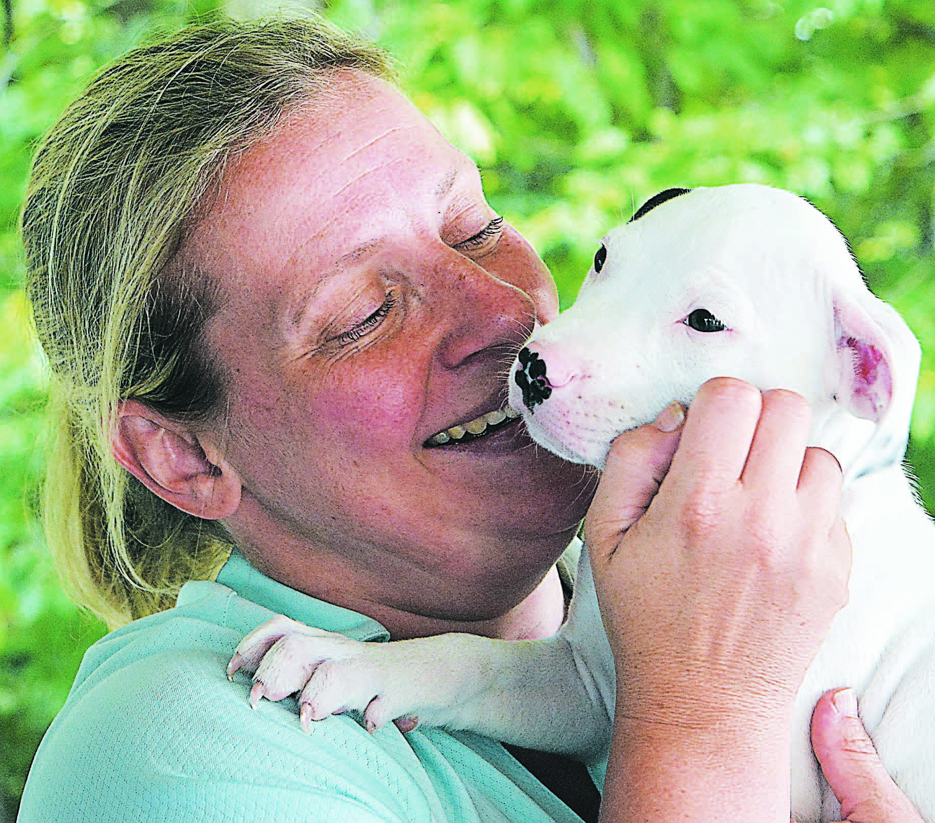 Jennifer Catalina, of Orion Twp., shares a tender moment with Orchis, an 8-week-old puppy available through Canine Companions Rescue Center. Photo by C.J. Carnacchio