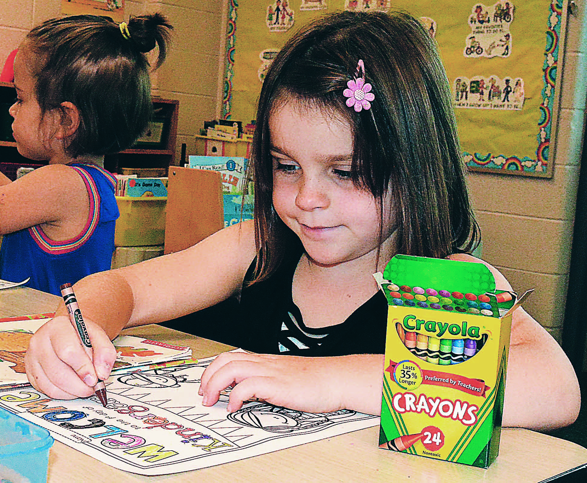 RIGHT: Madelyn Schenk colors her very first school assignment as a kindergartner at Daniel Axford Elementary. Photo by C.J. Carnacchio.