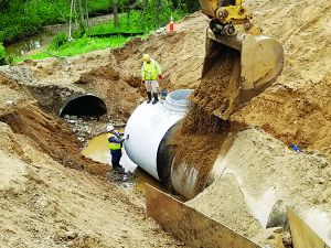 In early June, workers installed an 84-inch-diameter reinforced concrete pipe as the new culvert. Photo by Bill Dunn.