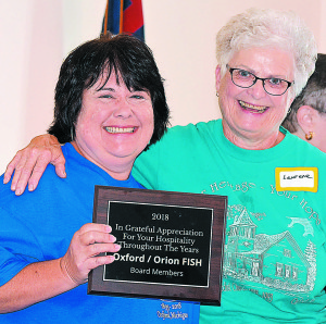 Oxford-Orion FISH President Laurene Baldwin (right) presented Springfield Township resident Dawn Raffler, a member of Thomas UMC’s leadership team, with a “hospitality award” to honor the church’s years of support. Photo by C.J. Carnacchio.