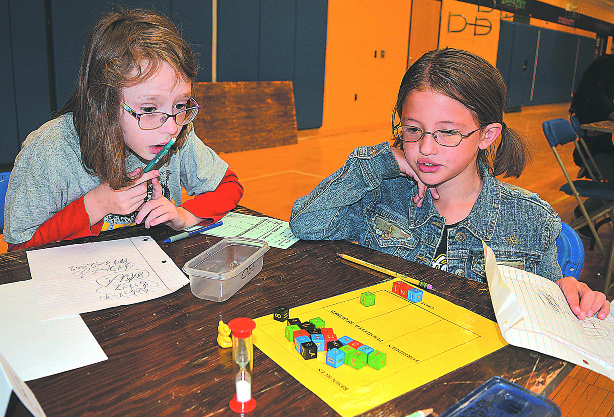 Contemplating their next moves are Sophia Schmalenberg (left), a third-grader at Clear Lake Elementary, and Celine Frank, a third-grader at Oxford Elementary. Photo by C.J. Carnacchio.