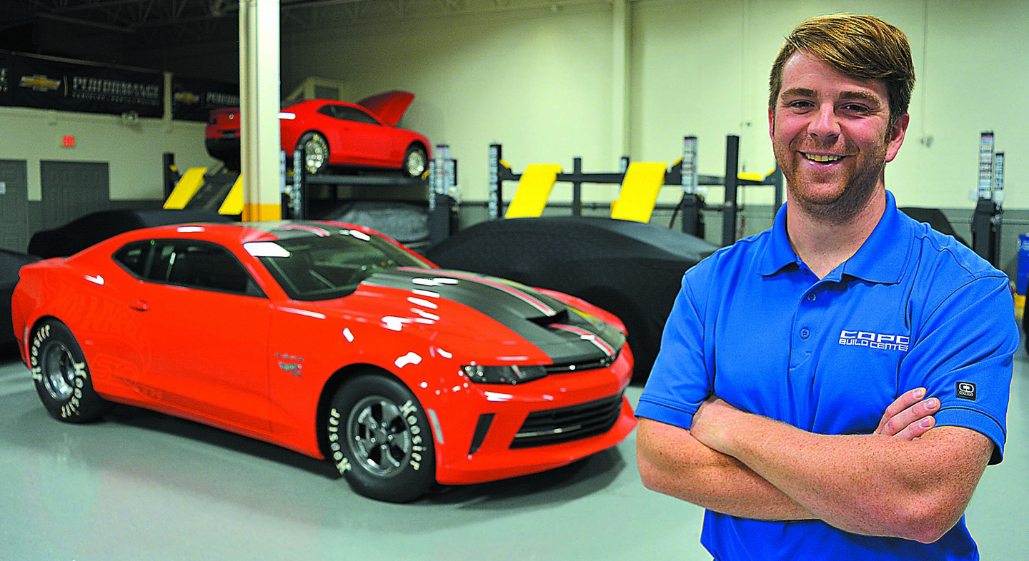 Mike Lawrence, a 2007 OHS graduate, is the operations manager at the COPO Build Center. Behind him is the 2018 COPO Camaro. Photo by C.J. Carnacchio.
