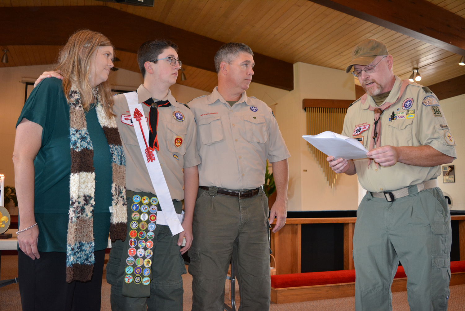 The Patterson family – (from left) Donica, Sean and Scott – listen to Assistant Scoutmaster Steve Patterson (no relation) deliver the Eagle Charge during the Court of Honor ceremony held Saturday afternoon at Oxford United Methodist Church. Photos by C.J. Carnacchio.