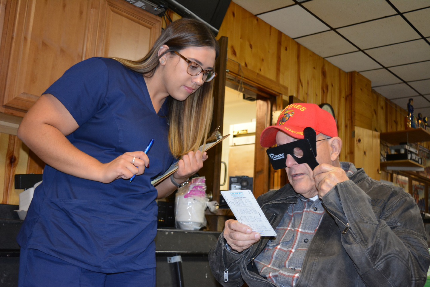 Oxford resident Hugh Syron, a Vietnam War veteran who served in the U.S. Marine Corps from 1965-69, gets his vision checked by  Kristen Cavazos, a student in the Ophthalmic Technician Program at Henry Ford College. Photo by C.J. Carnacchio.