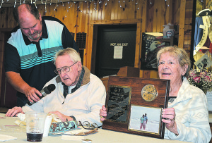 Harry Ahlborn (left) makes a few remarks to family and friends gathered at American Legion Post 108 in Oxford after he and his wife, Muriel (right), were presented with a plaque to commemorate their 75th wedding anniversary. Holding the microphone for him is his nephew Larry Ahlborn, of Oxford. Photo by C.J. Carnacchio.