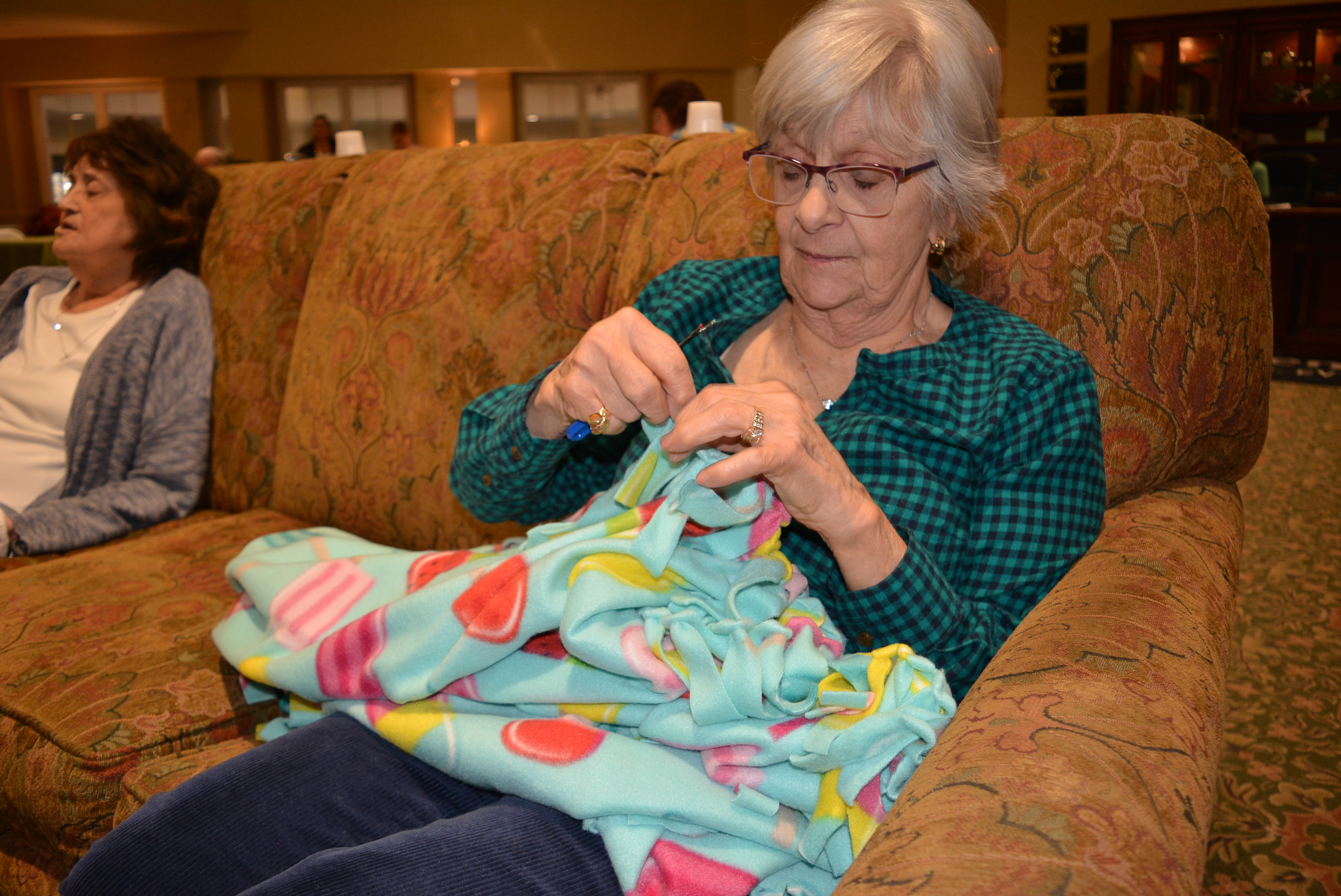Catherine Nanney puts the finishing touches on a blanket. Photo by C.J. Carnacchio.