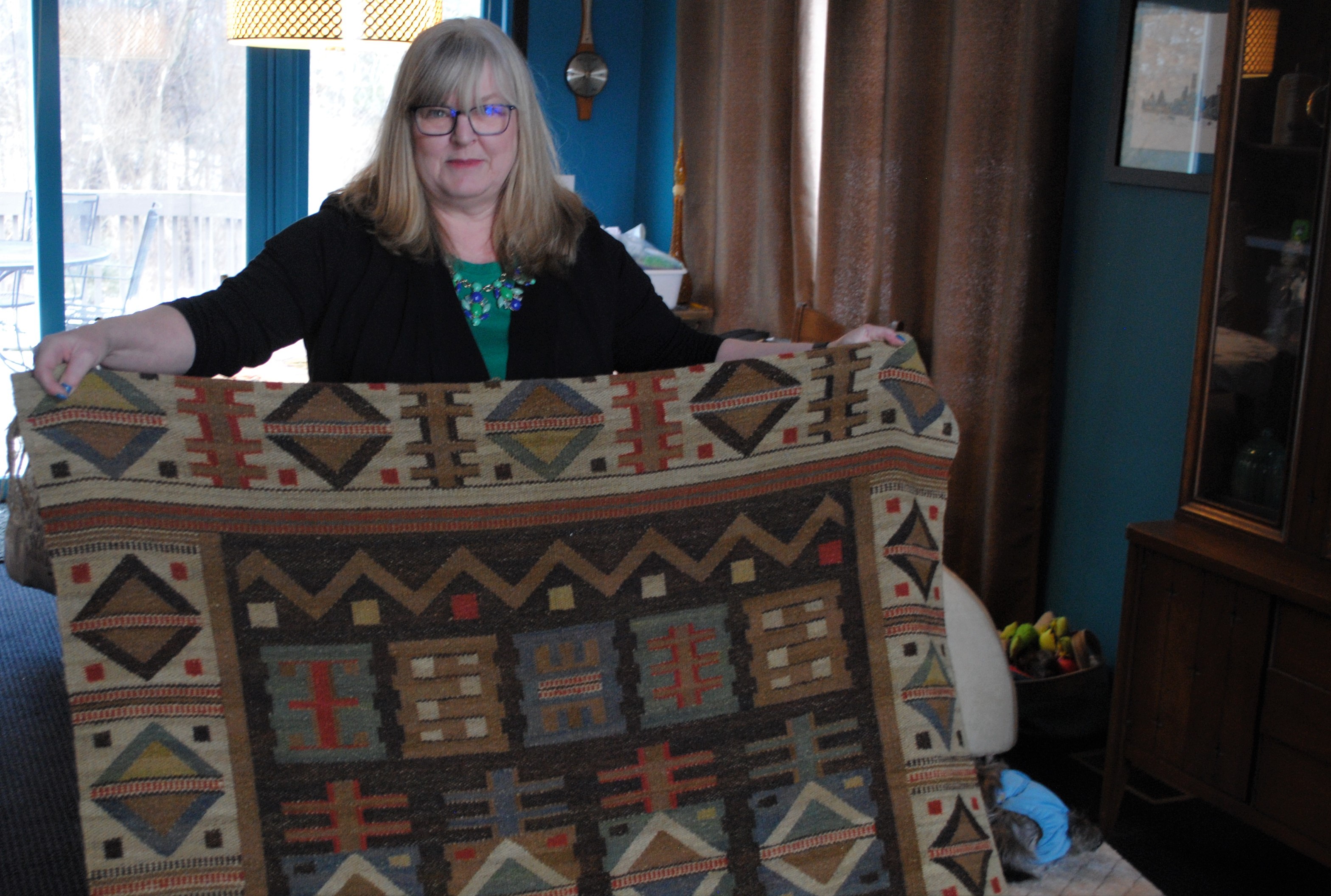 Oxford resident Devona Wassil was featured on “Antiques Roadshow” with the 1915 textile she’s holding. It was valued between $3,000 and $5,000. Photo by Shelby Tankersley. 