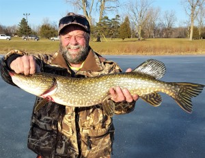 Oxford resident Hans Kalohn, creator of Fish Slime Paste, with a northern pike he hooked using his product. Photo provided.