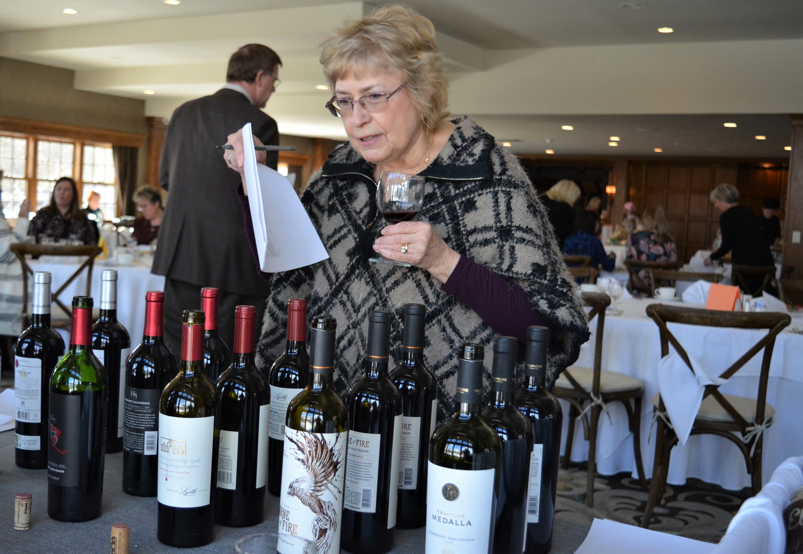 So much wine, so little time. Orion Twp. resident Janis Ripple checks out the diverse selection of red wines. Photo by C.J. Carnacchio.