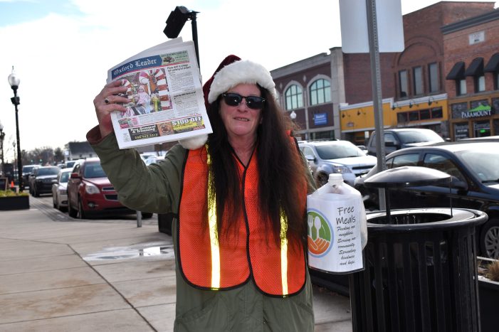 Extra! Extra! Volunteers sell The Oxford Leader to raise money for Free Meals program