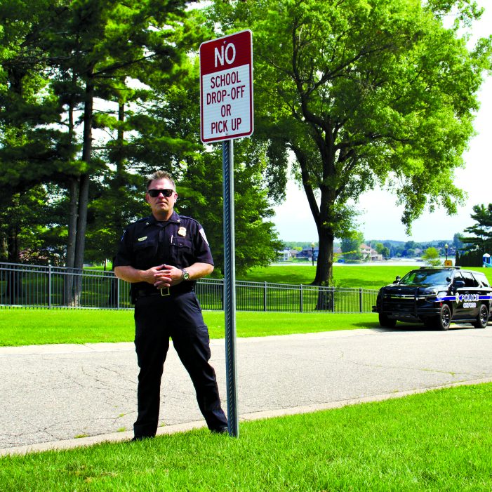 New signs warn parents about dropping students off on Lakes Edge Drive